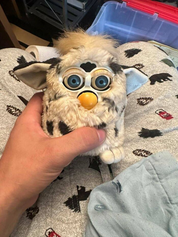 Hand holding a vintage Furby toy, a collectible item that is still valuable.