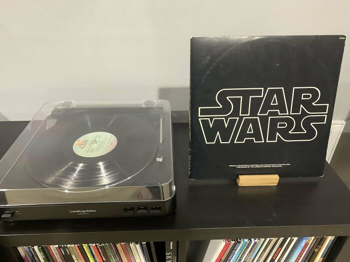 Vintage Star Wars vinyl record on display with record player nearby.