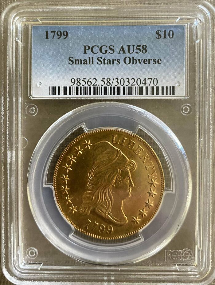 1799 vintage coin in protective case, labeled PCGS AU58, valued at $10, Small Stars Obverse.