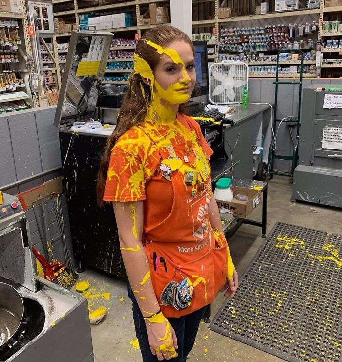 Worker at hardware store covered in yellow paint, representing a worst day at work scenario.