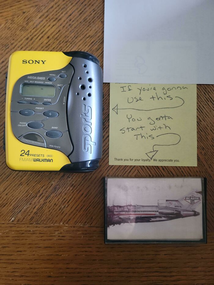 Vintage Sony Walkman with note on wooden table, highlighting its value as a collectible item.