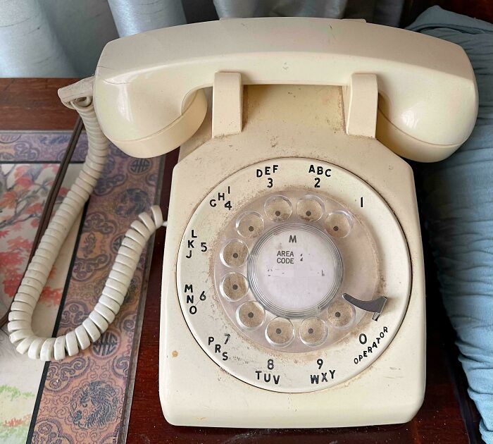 Vintage rotary phone with cream color, showing a classic design that remains valuable today.