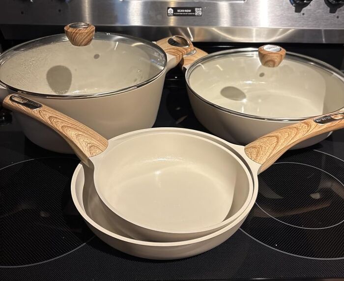 Ceramic cookware set with wooden handles on a stove, featuring bargain discounts for spring on Amazon.