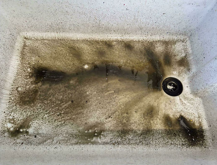 Dirty sink with grime and residue, reflecting the worst colleague cleanup habits.