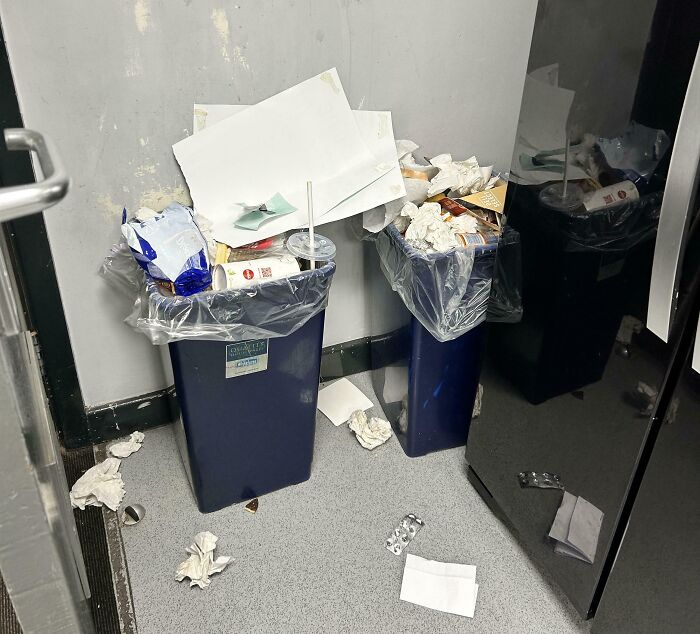 Overflowing trash bins in office, showcasing the worst colleagues leaving a mess.