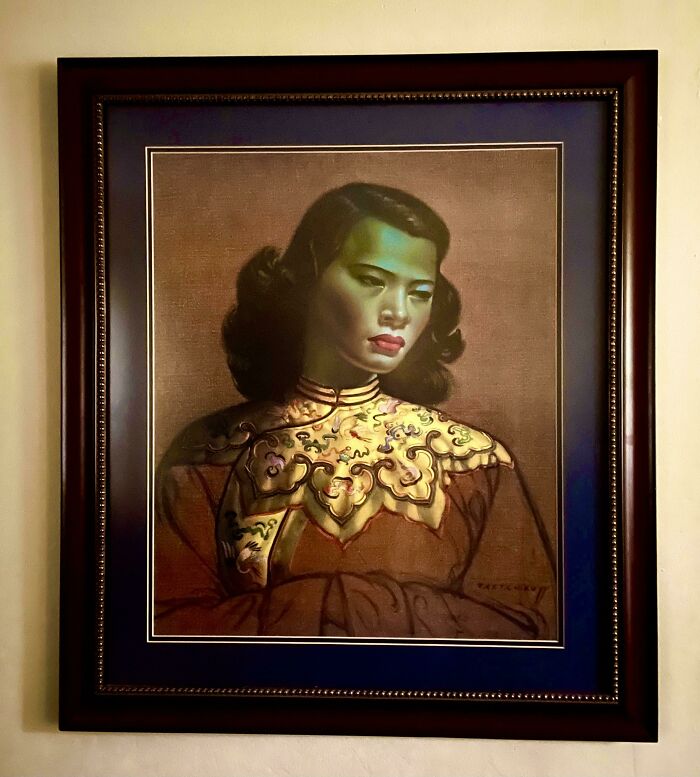 Vintage portrait of a woman in an ornate frame, showcasing timeless elegance and value.