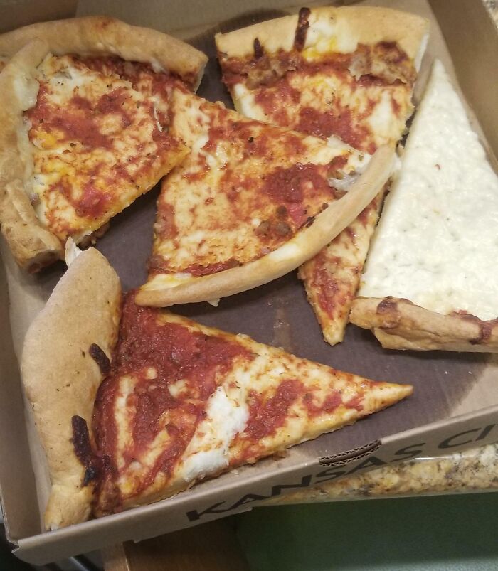 Unevenly cut pizza slices in a box, depicting a bad day at work mishap.