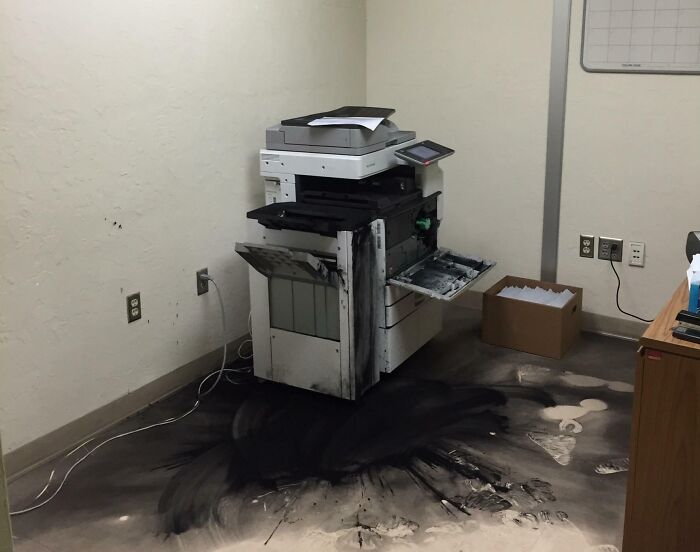 Office printer malfunction with toner spilled everywhere, marking a worst day at work scenario.