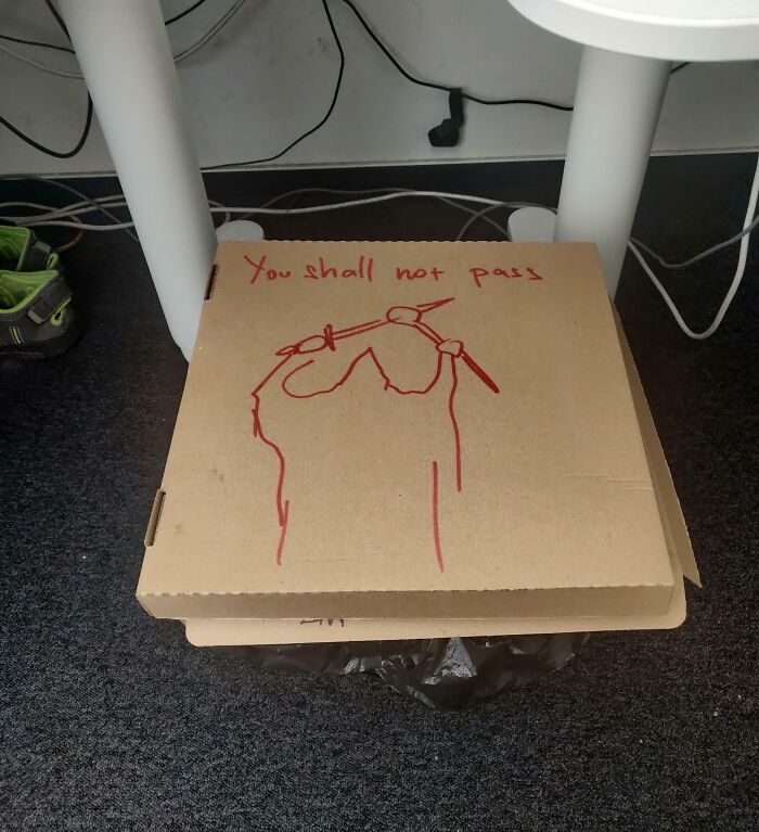 Pizza box with "You shall not pass" message drawn in red, illustrating bad colleagues scenario in an office setting.