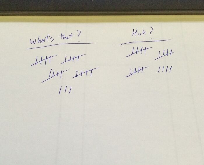 Tally marks on paper captioned "What's that?" and "Huh?", illustrating challenges with colleagues.