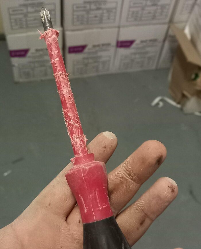 A poorly wrapped screwdriver in a messy workplace, showing frustration with colleagues.