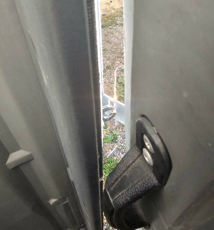 A door is awkwardly blocked by a lock and chain on the outside, showcasing workplace challenges with colleagues.