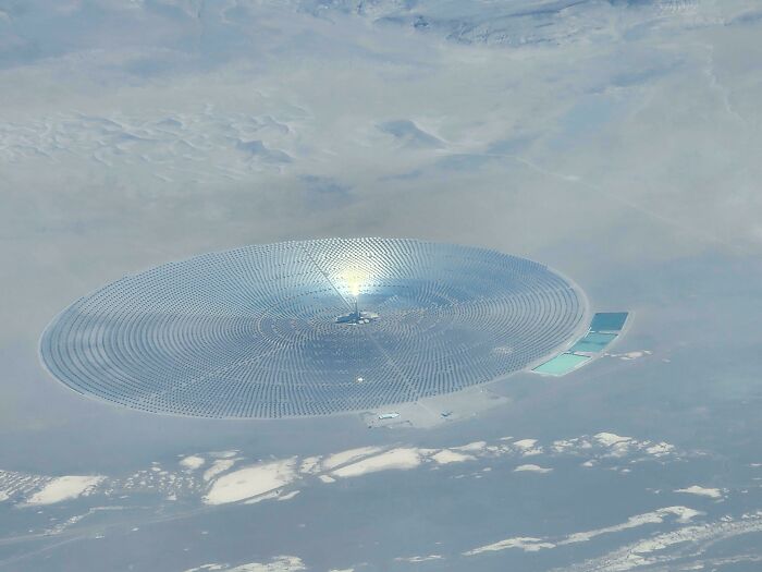 Aerial view of a large circular solar power plant showing our world is interesting and diverse.