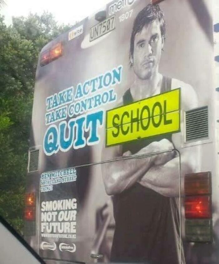 Bus ad with a design fail showing a man's image with confusing "QUIT SCHOOL" message on the back.