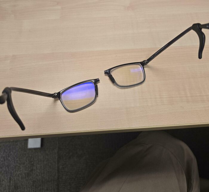 Broken glasses on a desk, representing a worst day at work scenario.