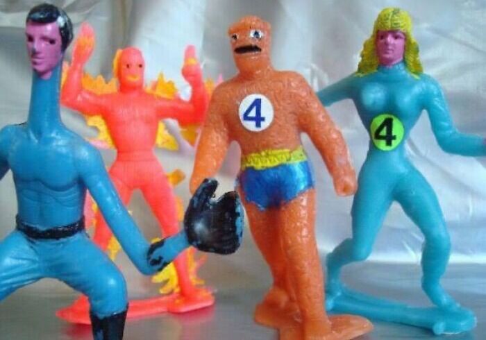Four poorly designed superhero figurines with mismatched features and colors, highlighting disastrous designs.