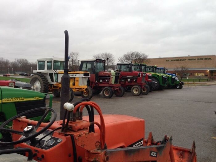 Tractors parked outside Cloverleaf High School, showcasing unique aspects of American schools.