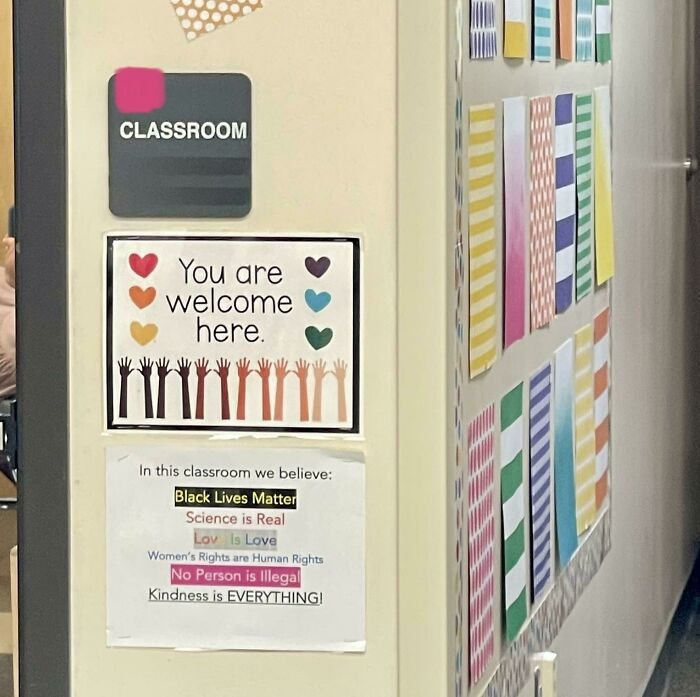 Classroom door with welcoming signs and colorful decor, emphasizing kindness and inclusion in an American school.