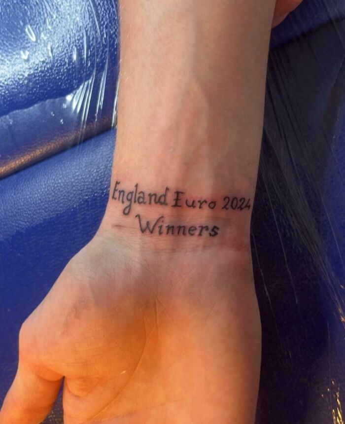 A wrist tattoo reads "England Euro 2024 Winners," reflecting a regrettable decision in context of worse day experiences.
