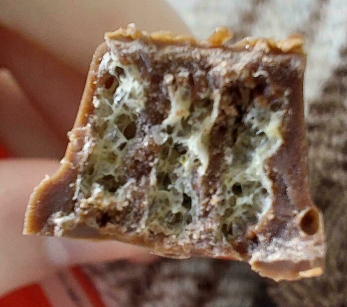 Close-up of a chocolate bar showing airy texture with nothing interesting seen.