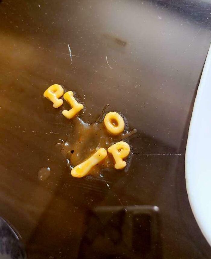 Alphabet pasta letters spell "RIP" on a dark surface, suggesting someone's worse day.