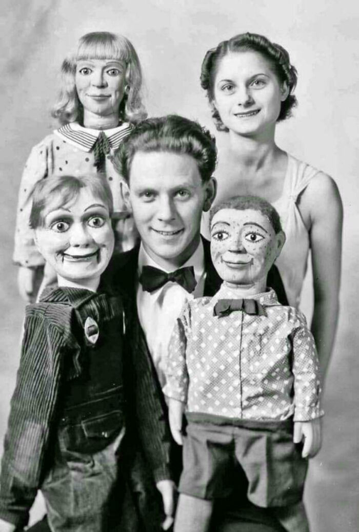 Man with ventriloquist dolls from the past, creating an unsettling scene.