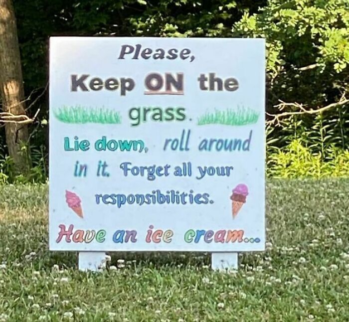 Sign on grass encouraging relaxation and ice cream, promoting a wholesome online vibe.