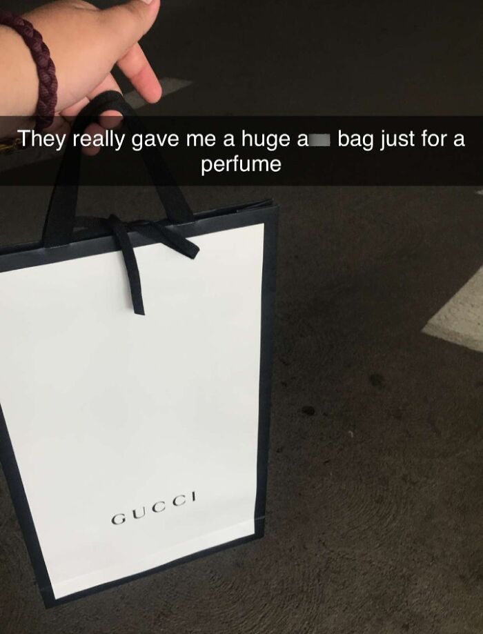Luxury shopping bag for a perfume, highlighting excessive wealth with Gucci branding.