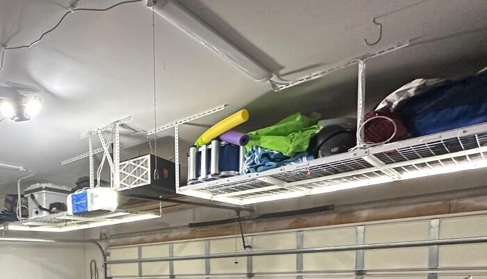 "Garage ceiling storage shelves holding various items, highlighting hidden contractor secrets."
