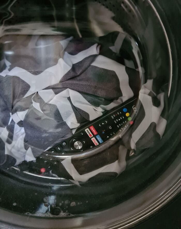 A remote control is accidentally washed with black and white clothes in a washing machine.