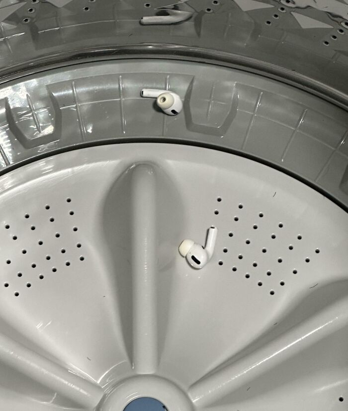 Earbuds stuck in a washing machine drum, having a worse day.