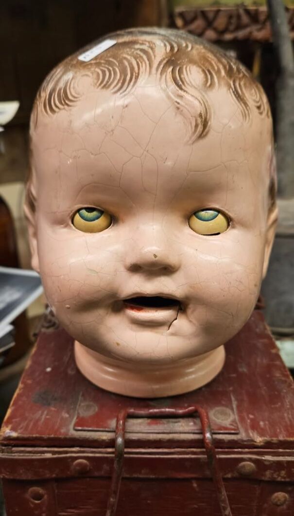 Creepy vintage doll head with c*****d face found while thrifting.