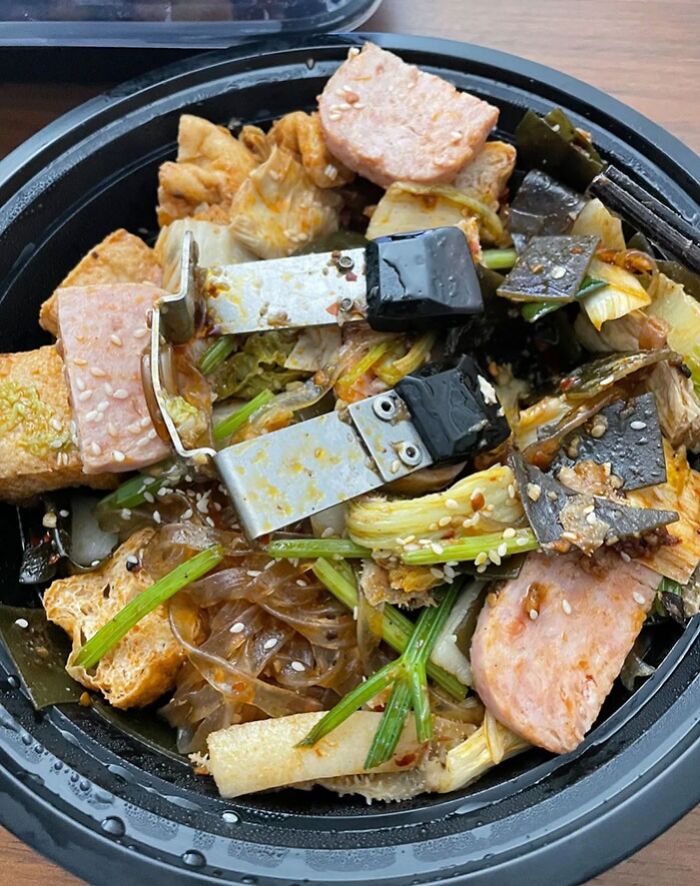 Food with a metal clip found inside, illustrating a disgusting discovery while trying to enjoy a meal.