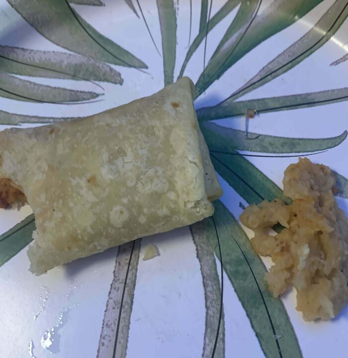 Food surprise: pastry on a plate with an unexpected plastic piece nearby.