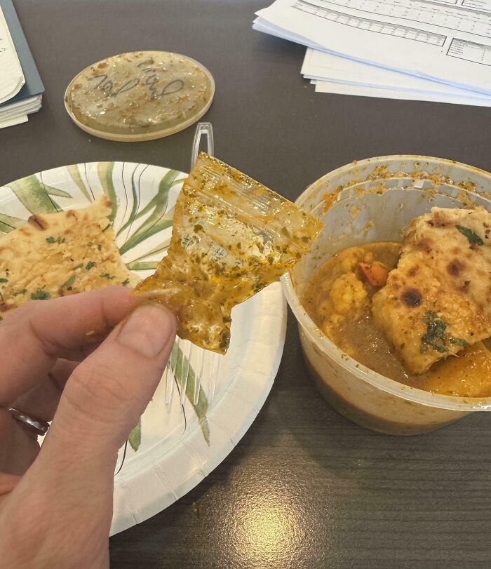 Hand holding a small plastic packet found in a meal, illustrating a food encounter that turned disgusting.