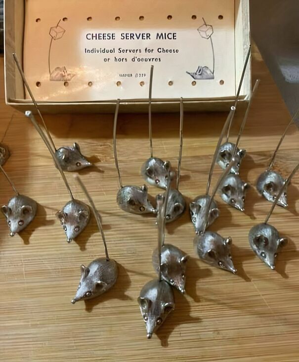 Unique thrifting find: silver cheese server mice with long tails displayed on a wooden surface.