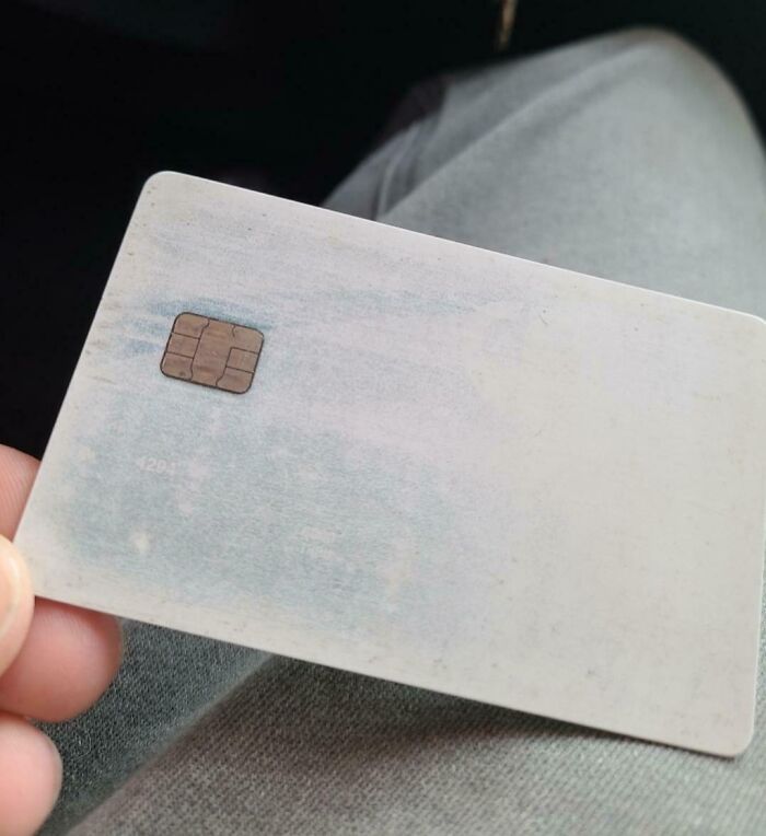 Worn-down credit card with a faded surface, showing effects of time.