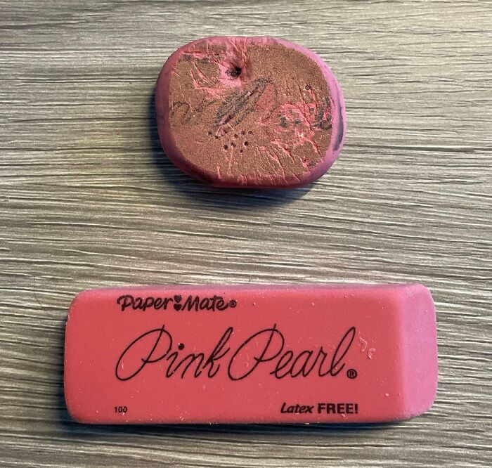 Worn-down eraser next to a new Pink Pearl eraser showing time's effects on belongings.