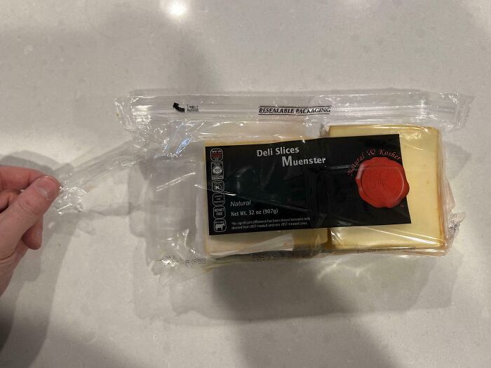 Pack of sliced Muenster cheese with broken resealable seal, a common in-law complaint.