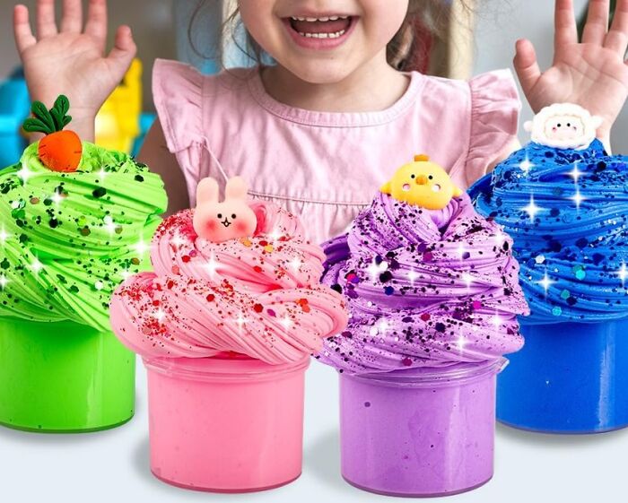 Colorful Easter basket stuffers with toy-topped slime in green, pink, purple, and blue jars.