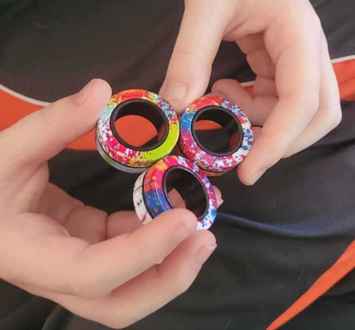 Colorful magnetic rings in hands, perfect Easter basket stuffers.