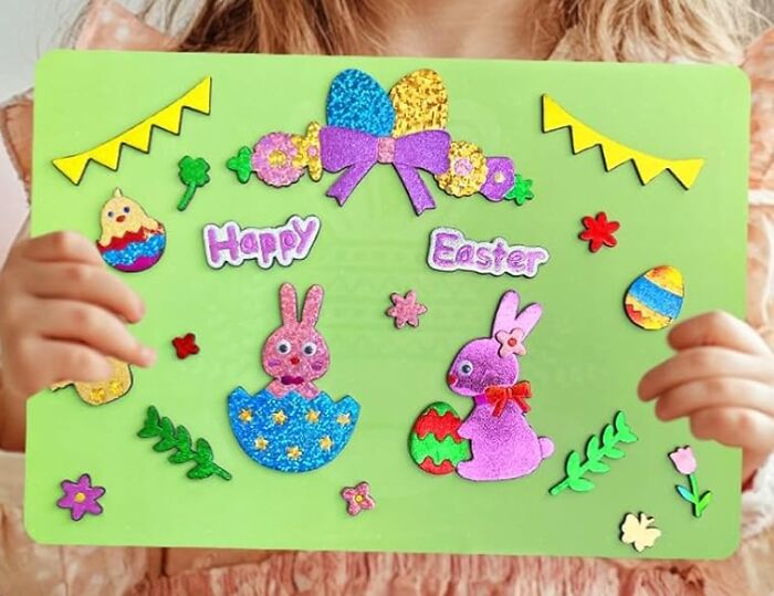 Child holding an Easter craft with colorful bunnies and eggs, perfect for Easter basket stuffers.