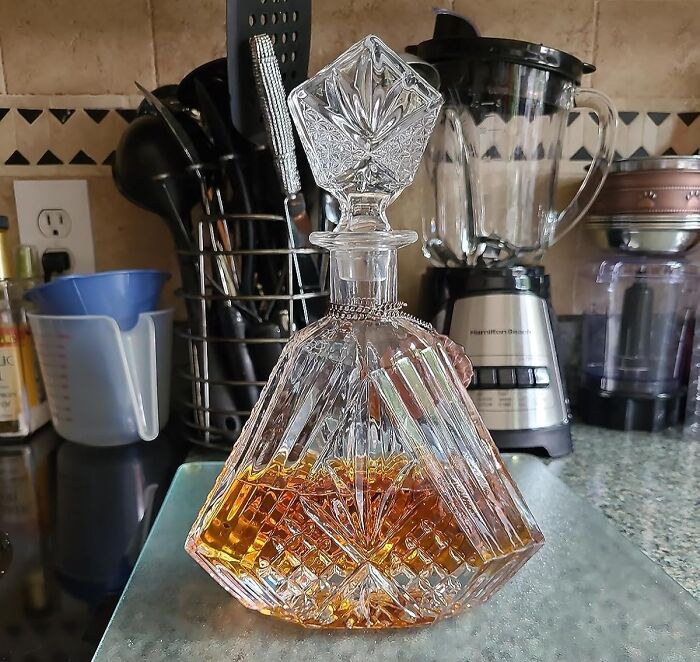Elegant glass decanter filled with amber liquid on a kitchen counter, representing a Costco a*******n solution.