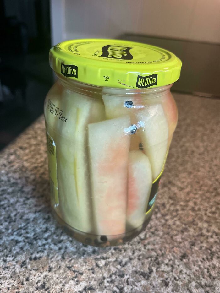 Jar of Mt. Olive pickled watermelon rind on a countertop, an old-school delicacy in nostalgic packaging.