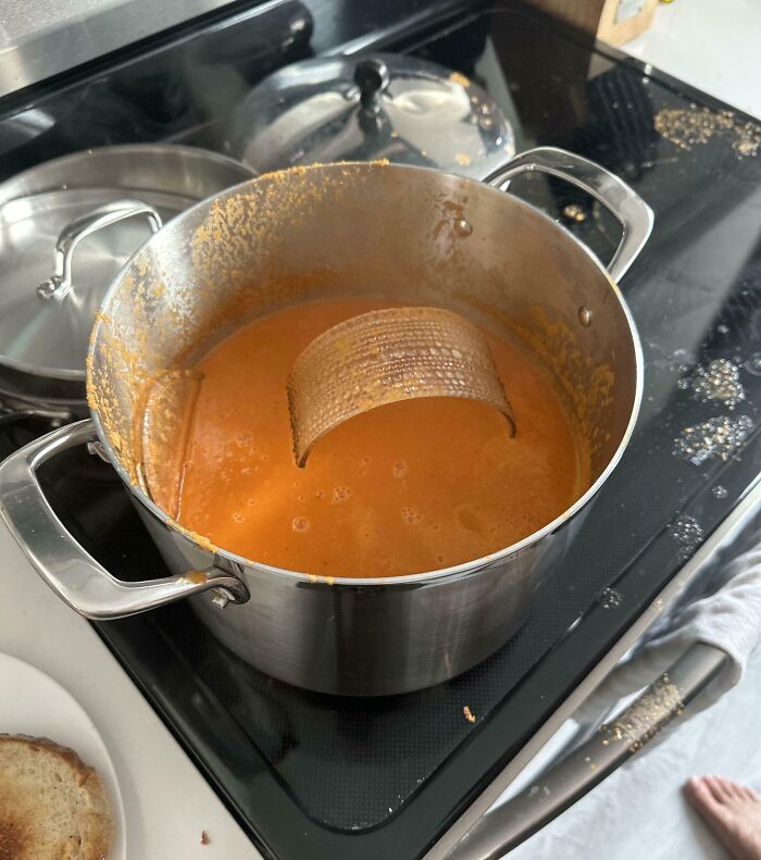 A pot of soup ruined by a scouring pad falling in, highlighting a horrible day cooking mishap.