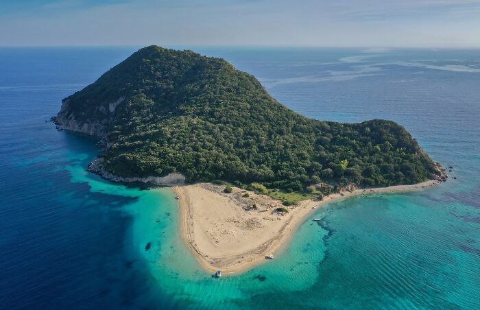Aerial view of a stunning beach with turquoise waters and lush greenery, perfect for a dream getaway.