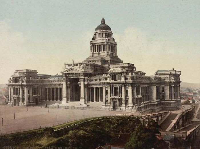 Old American architecture featuring a grand, neoclassical building with columns and a central dome.