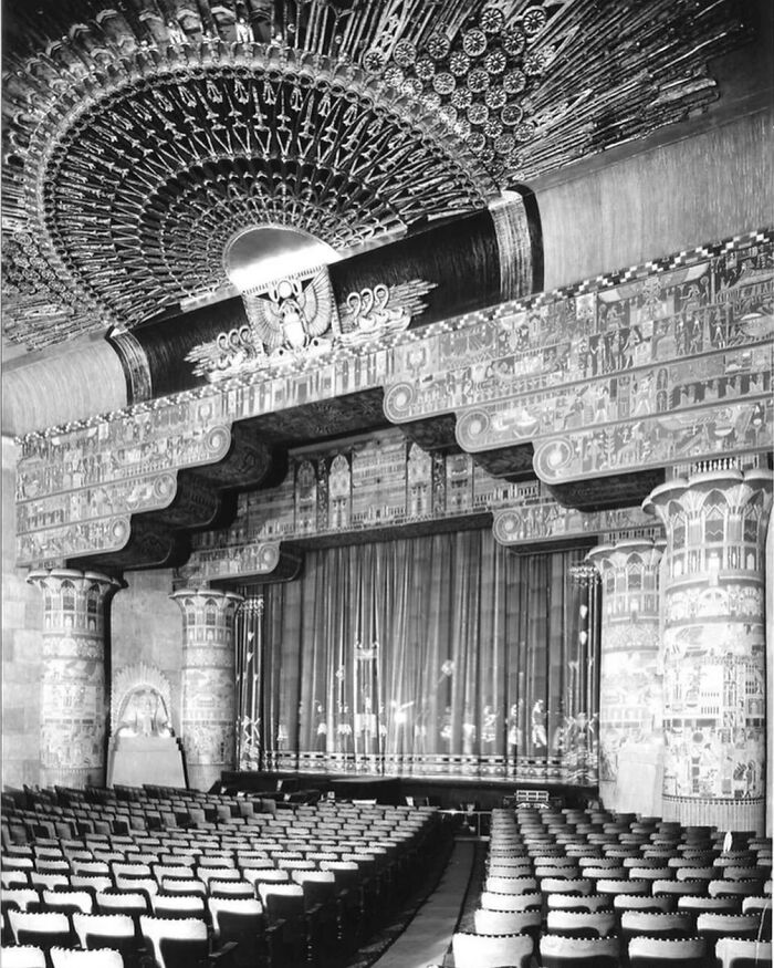 Ornate theater interior showcasing stunning old American architecture with intricate ceiling and decorative columns.