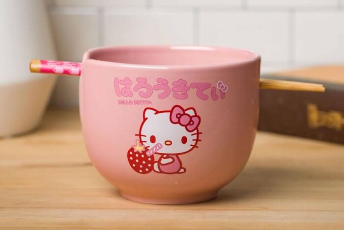 Pink Hello Kitty bowl with chopsticks, showcasing pure fandom goals.