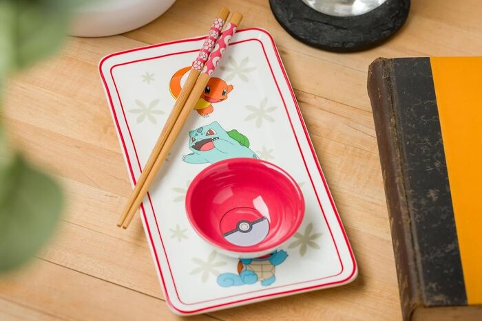 Fandom-themed plate and bowl set with chopsticks on a wooden table.